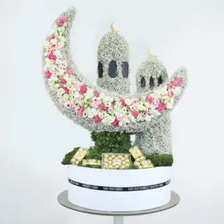 Ramadan-themed floral décor featuring a crescent moon and mosque towers made of fresh blooms.