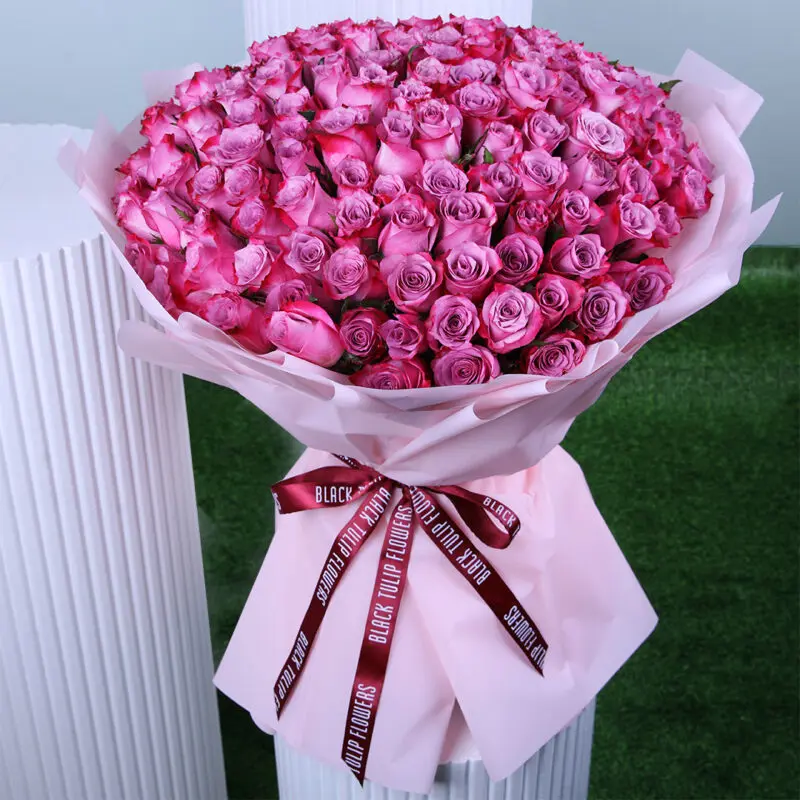 graceful-womens-rose-bouquet A luxurious Women's Day bouquet featuring soft pink roses, wrapped in blush pink paper and finished with a chic maroon ribbon.