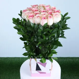 Serene pink roses in a stylish floral bag with lush greens