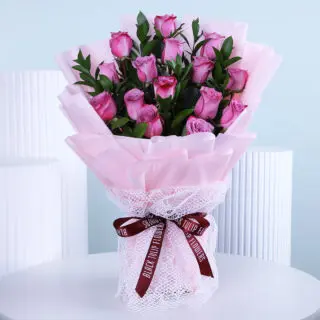 Hand-tied bouquet of roses and greenery, elegantly arranged for Women's Day.