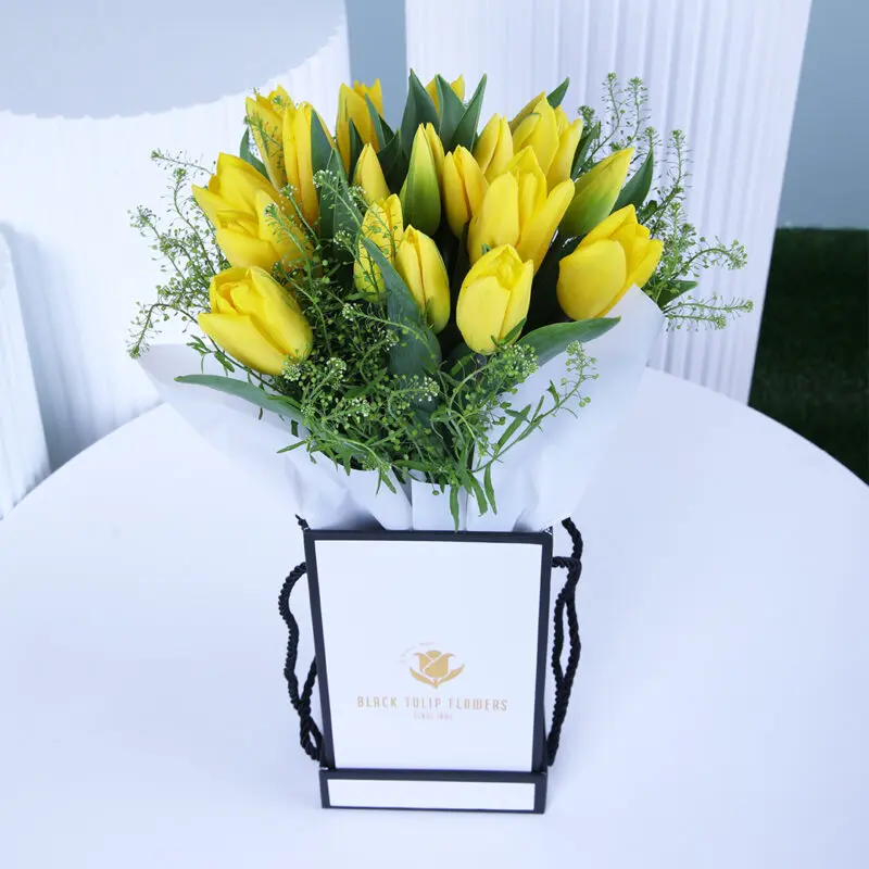 yellow tulips Yellow tulips floral box in a white wrap, elegantly presented with a gift box.