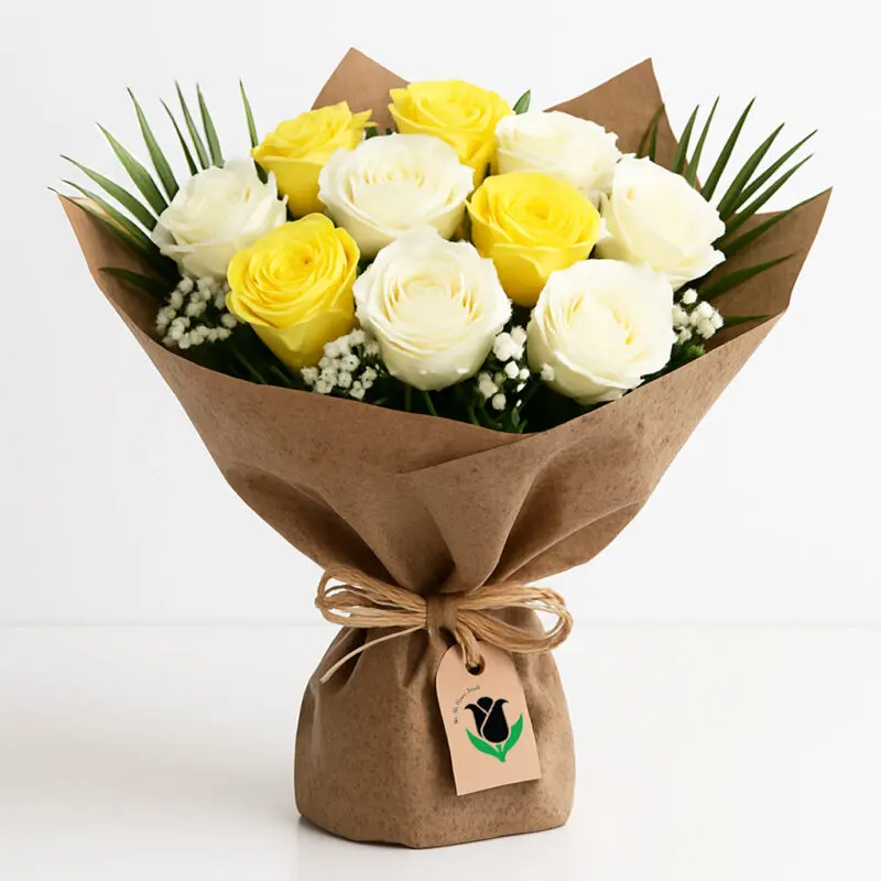 yellow-white-rose-bouquet A bouquet featuring yellow and white roses, complemented by white gypsophila and green leaves, all wrapped in brown paper.