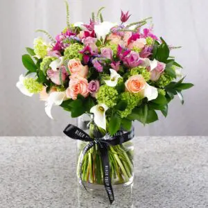 Capturing excellence of floral vibes that would give a positive mood. This flower arrangement composed with mix of fresh flowers in a glass vase.