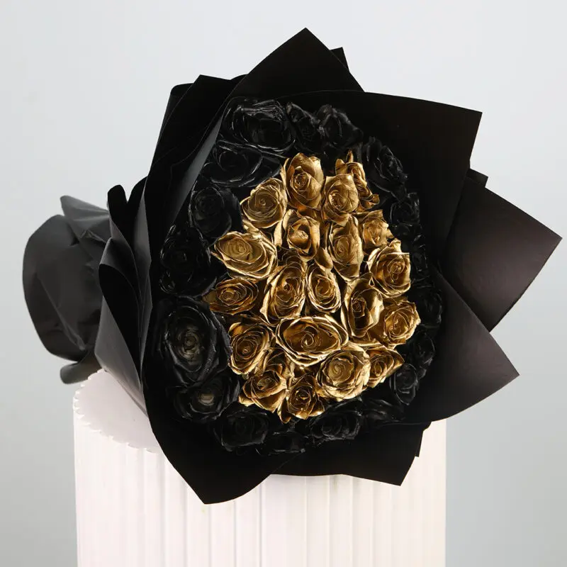 black-gold-rose-bouquet A luxurious bouquet of black and gold roses wrapped in black.