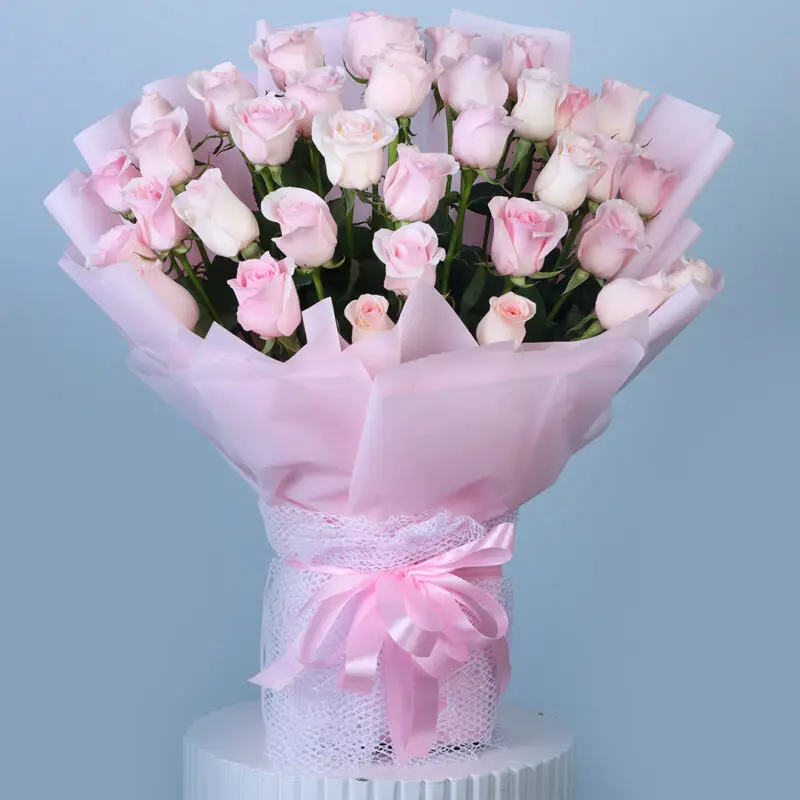 pink-rose-bouquet A beautiful bouquet of soft pink roses wrapped in pink and tied with a pink lace ribbon.