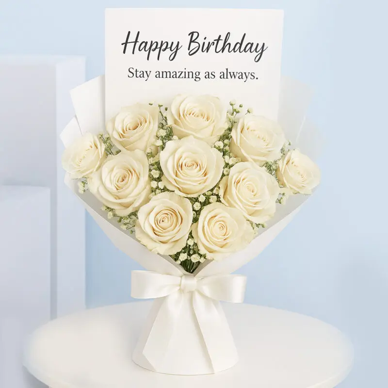 cream-rose-bouquet A bouquet of Cream roses with delicate baby's breath, wrapped in white paper and tied with a satin ribbon, with a "Happy Birthday, Stay amazing as always." card.