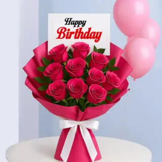 A bouquet of pink roses with a "Happy Birthday" card with three pink balloons in the background.
