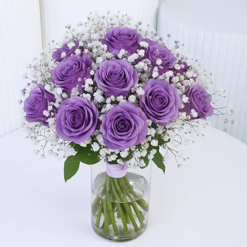 purple-rose-vase A luxurious bunch of purple roses with baby’s breath in a clear glass vase.