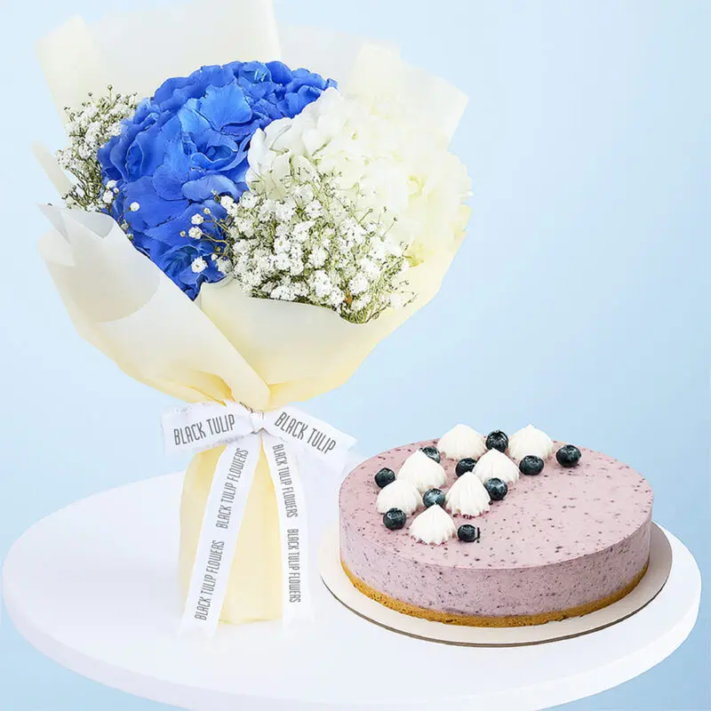 white-blue-hydrangea-bouquet-cake-01 A flower combo featuring a bouquet of blue and white hydrangeas and baby's breath wrapped in cream and a purple-colored cheesecake.