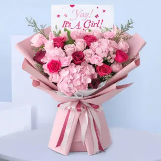 “It’s a Girl” pink bouquet with roses and hydrangeas - new baby flower arrangement wrapped in blush pink paper.
