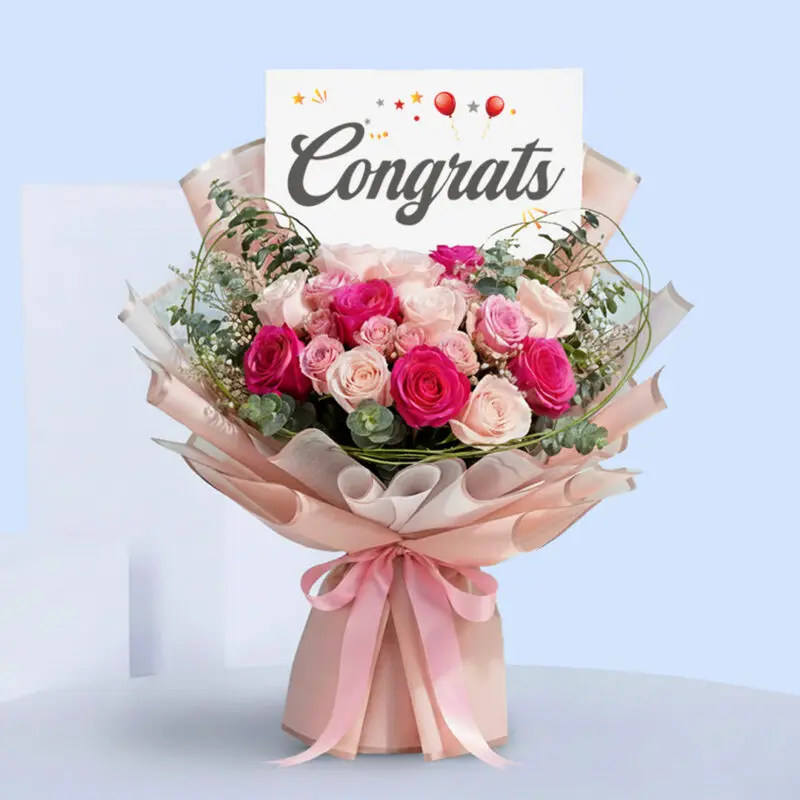 pink-roses-congrats-bouquet-17-10 Pink roses congratulations bouquet with eucalyptus in blush pink wrap, tied with a satin ribbon and a “Congrats” card.