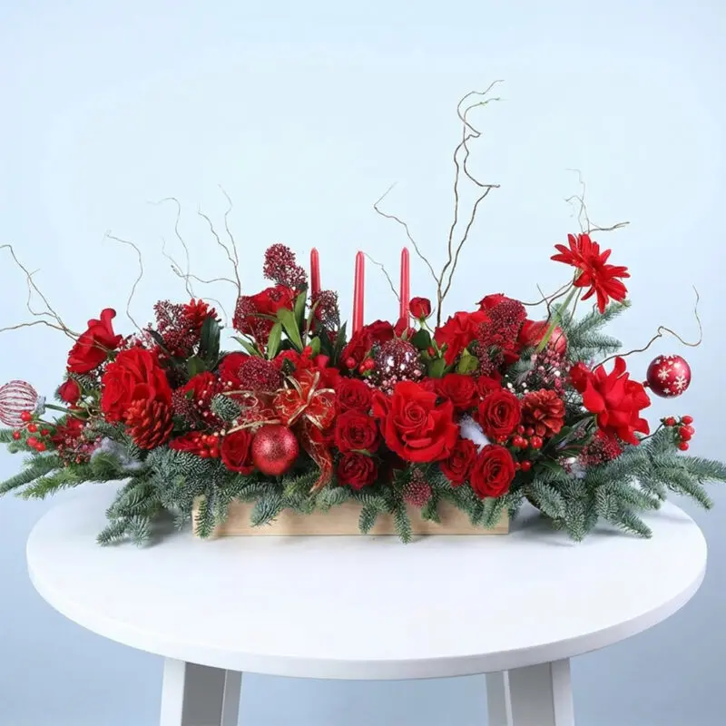 christmas-candle-tray-with-red-flowers-25 Christmas candle tray with red anthuriums, red roses, Nobilis leaves, and Brown sticks in a wooden tray.
