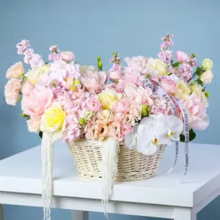 Pastel rose, hydrangea, lisianthus, mattiola, ranunculus, amaranthus and orchid flower basket arrangement