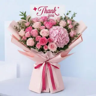 Thank You bouquet with pink roses, spray roses, and pink hydrangea in pink wrap.