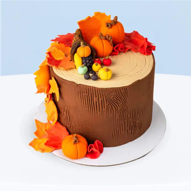 thanksgiving-harvest-cake-1kg Thanksgiving theme cake decorated with pumpkins, autumn leaves, and cornucopia on a wooden-textured design.