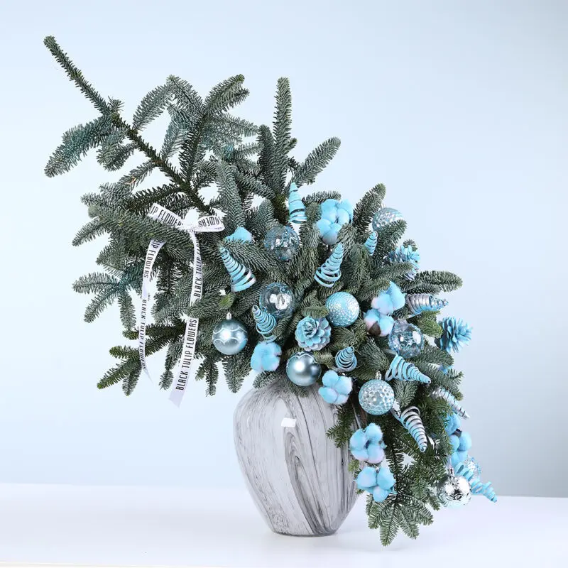 blue-nobilis-christmas-vase Blue Christmas arrangement with Nobilis leaves, ornaments, and fillers in a designer vase.