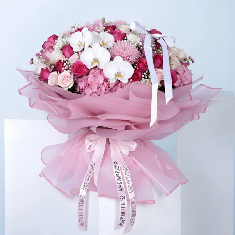 pink-hydrangea-rose-gypso-mixed-flower-bouquet A bouquet featuring pink hydrangea, roses, gypsophila, and mixed flowers in premium pink wrapping with a satin bow.