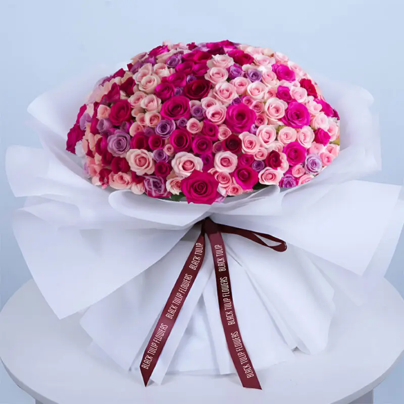 pink-purple-rose-bouquet Bouquet featuring dark pink & peach spray roses with pink roses and purple roses in premium white wrap.