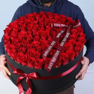 Valentines Day Home 66 Luxury Valentine flower box featuring 100 red roses arranged in a black round box with red ribbon bow.