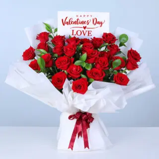 Valentines Day Home 25 Bouquet of 25 red roses and lush greenery in white wrapping, finished with a message card.