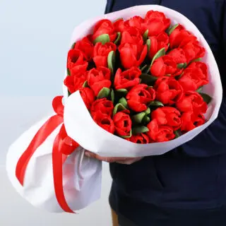 Valentines Day Home 21 Bouquet of 30 red tulips in a white wrap style, finished with a red ribbon.