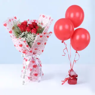 Bouquet of 7 red roses, gypsophila, and lipidium in heart-print wrapping, paired with red balloons.