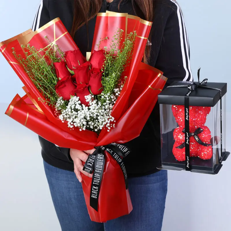 7-red-roses-gypsophila-teddy-gift_2026 Bouquet of 7 red roses, gypsophila, and lepidium in red premium wrapping, with a small teddy.