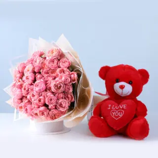 20 Bombastic light pink roses bouquet in premium wrapping, paired with a red teddy bear.