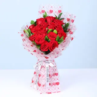 Valentines Day Home 38 New Elegant Valentine bouquet of red roses and baby’s breath in heart-pattern wrapping.