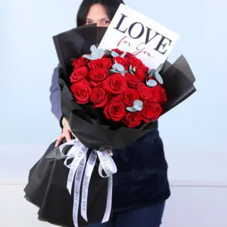 Valentines Day Home 23 A bouquet of red roses and eucalyptus in black wrapping, finished with a Love For You card.