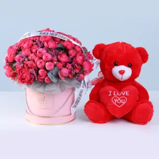 Bombastic purple rose peony blooms and pink casbia in a pink box with red teddy.