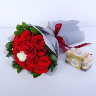 Valentines Day Home 53 Bouquet of 14 red roses, 1 white rose, ruscus leaves and Ferrero Rocher chocolates in a grey wrap with a red ribbon.