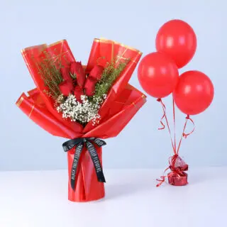 A bunch of red roses mixed with baby’s breath and some green fillers, all wrapped up in peach paper, accompanied with 3 red balloons.