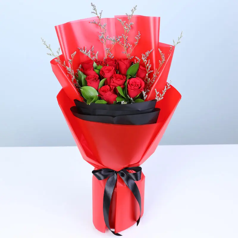 red-roses-bouquet-red-black-wrap Red roses bouquet with greenery in bold red and black wrapping.