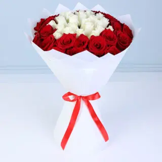 Fresh flower bouquet with red and white roses arranged in a balanced round shape, creating a visually pleasing romantic design