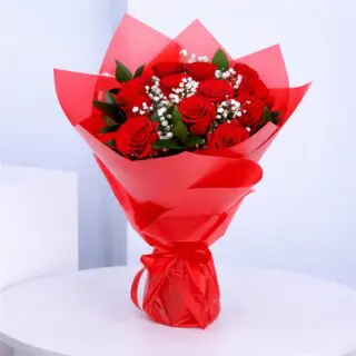 Red roses with baby’s breath and green foliage in red premium wrapping, finished with a ribbon.