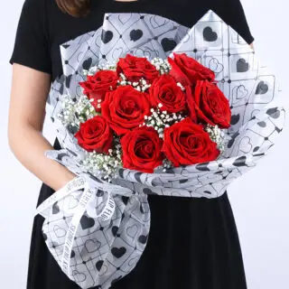 Valentines Day Home 41 A bouquet of red roses and baby’s breath in a heart-patterned white wrap, finished with a Valentine’s Day romantic presentation.