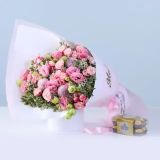 Bouquet featuring pink lisianthus, reflex baby roses, ping pong chrysanthemums and seasonal greenery in elegant pastel wrapping, paired with 16pcs Ferrero Rocher chocolates