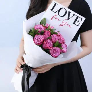 Purple roses arranged in a hand-tied style in premium wrapping, with a "LOVE for you" message card.
