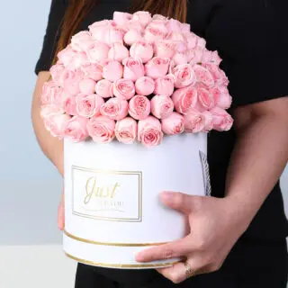 Premium pink roses in a white luxury round box with gold detailing, finished with a Just For You message label.