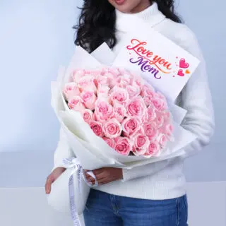 Ribbon-wrapped bouquet of 40 tender pink roses with a message card, perfect for surprising your mom on Mother’s Day.
