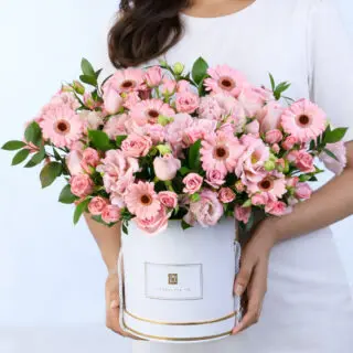 Romantic pastel blooms in a white gift box, combining pink Lisianthus, Gerbera, Roses, and fresh foliage.