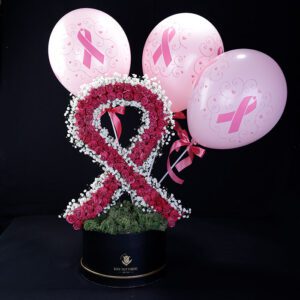 Pink ribbon made of flowers and balloons for breast cancer awareness.