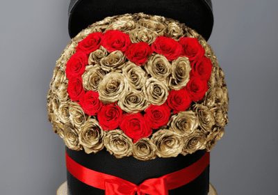 red heart and golden roses in a box