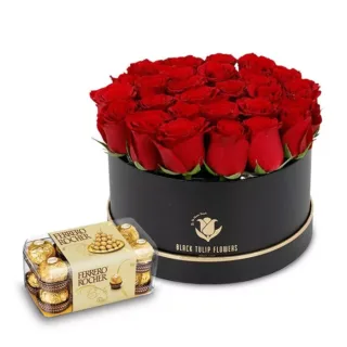 Elegant red roses arranged in a black box, complemented with a box of Ferrero Rocher chocolates.