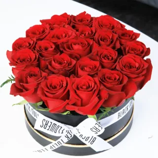 Valentines Day Home 63 Stunning display of red roses arranged in a black box, elegantly tied with a white ribbon.