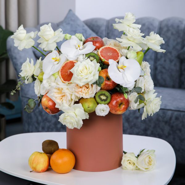 Peaceful Fruit Arrangement composed of mix fruits and flowers in a box by Black Tulip Flowers.