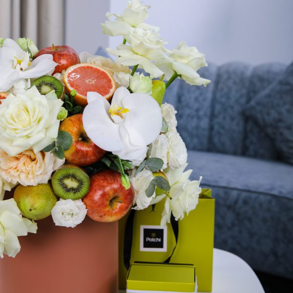 Peaceful Fruit Arrangement composed of mix fruits and flowers in a box with Patchi by Black Tulip Flowers.