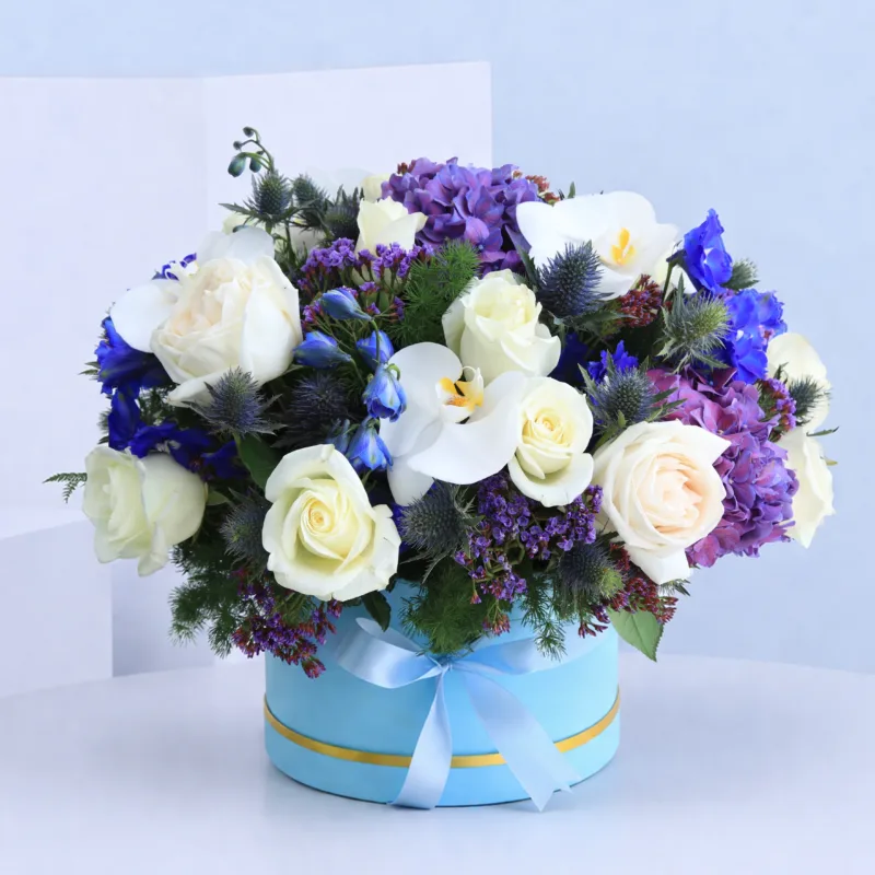 majestic-chemistry_2026 A blue flower box filled with a vibrant mix of exotic flowers, showcasing their beauty and bold colors.