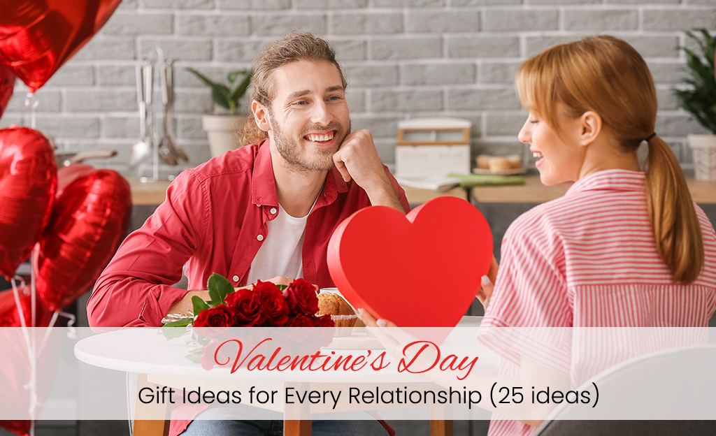 A girl, holding a gift card in her hand, her boy sitting next to her in a hotel decorated with Valentine's Day balloons and flowers.
